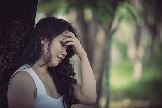 Beautiful thai woman very sad from unrequited love,She rethink and think over about love,vintage style,dark tone,broken heart,asian girl think a lot because she fat