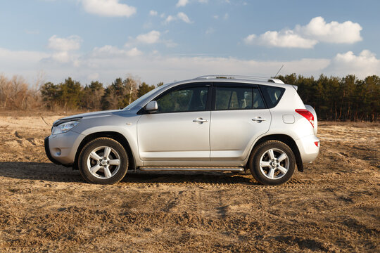 Dnipro, Ukraine - February 19, 2020: Toyota Rav4 2006 gray color among the sand near the forest, open space on sunset