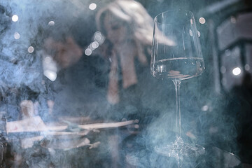 Obraz na płótnie Canvas restaurant table view evening wine glass, friends at the party