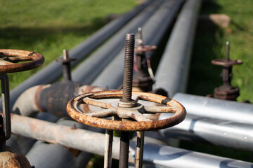 Rusty valve to shut off water pipes. Factory communications. Metal parts of the pipeline.