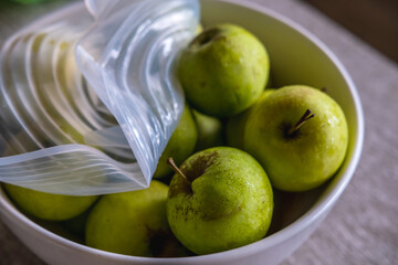 Apples packed with environmentally safe round silicone stretch lid ready for storage. Reusable eco-friendly kitchen products. Zero waste sustainable plastic free lifestyle