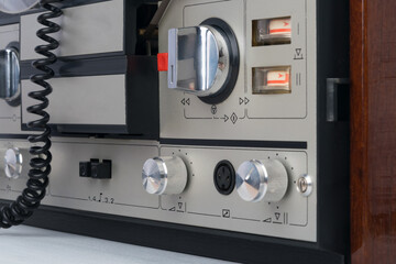 close-up of the buttons and volume controls of an old tape recorder
