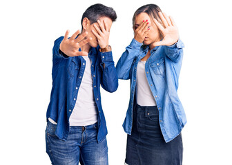 Couple of women wearing casual clothes covering eyes with hands and doing stop gesture with sad and fear expression. embarrassed and negative concept.