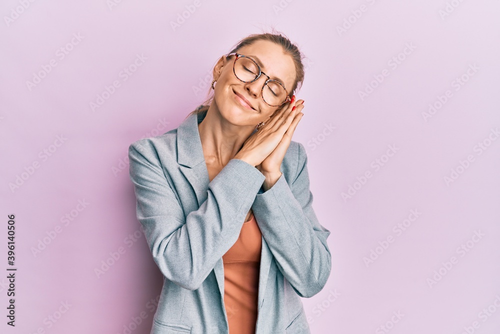 Canvas Prints Beautiful caucasian woman wearing business jacket and glasses sleeping tired dreaming and posing with hands together while smiling with closed eyes.