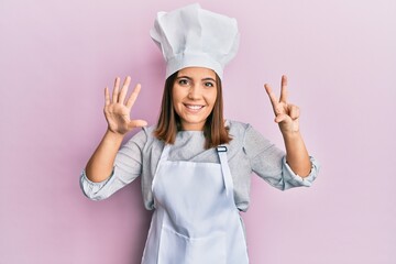 Young blonde woman wearing professional cook uniform and hat afraid and terrified with fear expression stop gesture with hands, shouting in shock. panic concept.