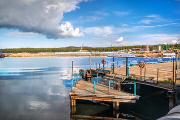 Fototapeta na wymiar Tamarin pier for ships on the Solovetsky Islands. Caption: Tamarin pier