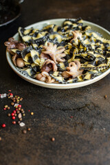 pasta ink cuttlefish seafood farfalle with baby octopus small octopuses second course snack ready to eat on the table healthy meal snack ingredient top view copy space for text food background rustic