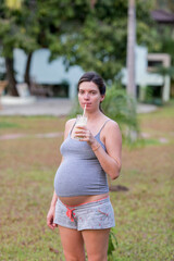 Happy pregnant woman with big pregnant belly smiling