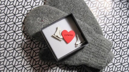 An open gift. The box contains a heart and toy skates.            
