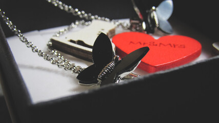 Open gift close-up. Heart and earrings in a box.               