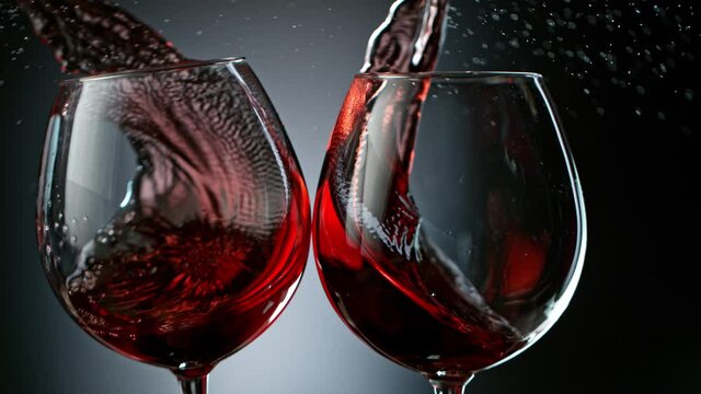 Super Slow Motion Shot of Clinking Two Glasses of Red Wine at 1000fps.