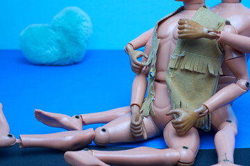 A gay couple of male dolls cuddling in bed. LGBT prideA gay couple of male dolls cuddling in bed with a blue stuffed heart. LGBT pride