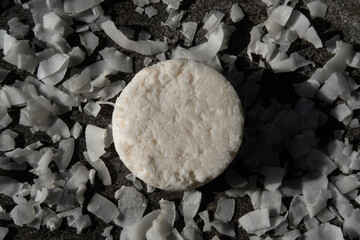 Natural eco friendly solid coconut shampoo bar, conditioner, soap or shaving bar on stone background. Zero waste and sustainable plastic free lifestyle