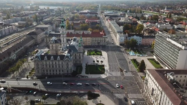 Aerial / drone birdseye footage of the Győr Town Hall in downtown Győr, capital of Győr-Moson-Sopron County, Western Transdanubia region in Norhwestern Hungary