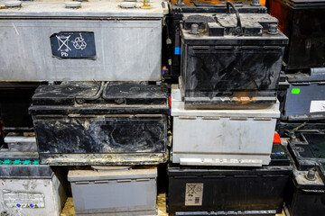 A pallet with used car batteries awaiting recycling