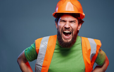 Male worker in orange paint emotions construction studio