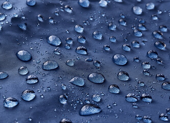 Rain water droplets on waterproof fabric.