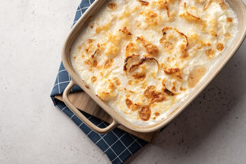 White fish casserole with cheese, sour cream and onion