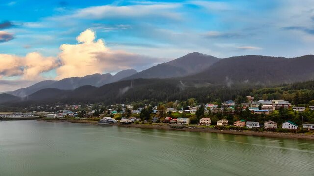 Cinemagraph Continuous Loop Animation. Beautiful view of a small town, Juneau, with mountains in the background. Colorful Sunset Sky. Taken in Alaska, United States.