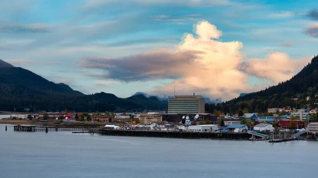 Cinemagraph Continuous Loop Animation. Beautiful view of a small town, Juneau, with mountains in the background. Colorful Sunrise Sky. Taken in Alaska, United States.