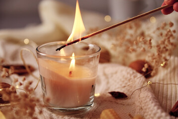 Burning candle and christmas decorations, top view. Winter cozy home and hygge concept