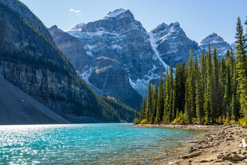 Naklejka na ściany i meble Moraine lake beautiful landscape in summer sunny day morning. Sparkle turquoise blue water, snow-covered Valley of the Ten Peaks. Banff National Park, Canadian Rockies, Alberta, Canada