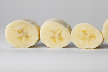 Sliced banana slices on a white background close-up
