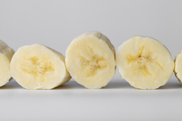 Sliced banana slices on a white background close-up