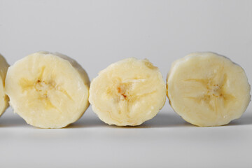 Sliced banana slices on a white background close-up