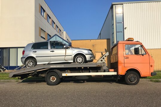 Almere, the Netherlands - September 2, 2018: Damaged car ( Polo) on a platform of a tow truck.