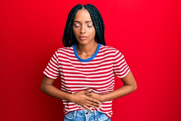 Beautiful hispanic woman wearing casual clothes with hand on stomach because indigestion, painful...