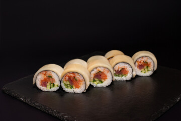 sushi hot rolls on black background dish japanese cuisine