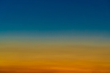 Background with gradient susnet sky in tones of yellow, orange and blue