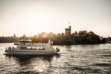 Stockholm commuter boat at sunset. Beautiful golden light. Stockholm, Sweden -Image