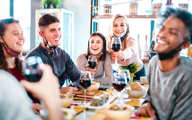 People toasting red wine at fashion restaurant bar with open face mask - New normal lifestyle concept with happy friends having fun together on bright filter - Focus on middle frame brunette woman