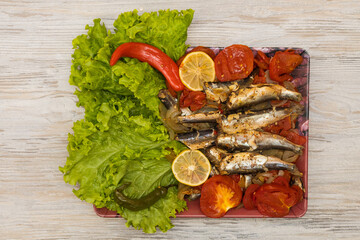 Fish stewed in vegetables with lemon. Culinary background with selective focus