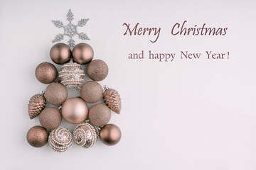 Christmas figure made of Christmas balls on a white background. The view from the top. Toning. Holiday greeting card with the text-Merry Christmas.
