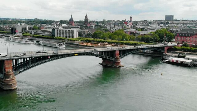Aerial view of cars on a the Theodor Heuss bridge, cloudy day, on Rhein river, in Mainz, Germany - pull back, drone shot