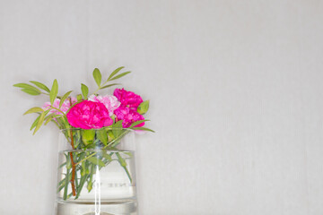 flowers in a cup stand on the table
