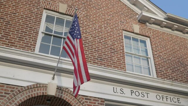America flag hanging over post office entrance
