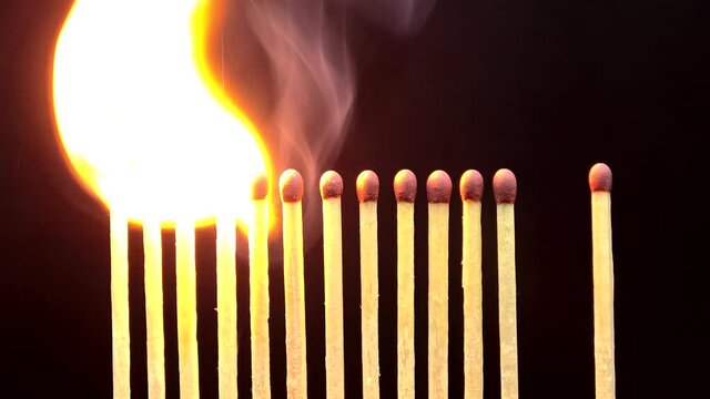 Burning matches on black background. Coronavirus Covid-19 outbreak and social distancing concept. Stop the spread of the pandemic