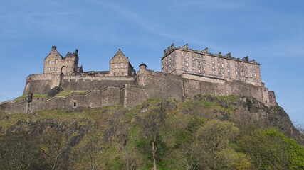 Grey buildings of Edinburgh castle standing tall above the city