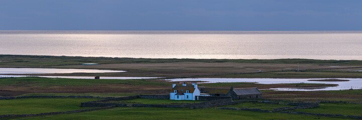 Small cottage in the distance on South Uist, Outer Hebrides, Scotland, UK