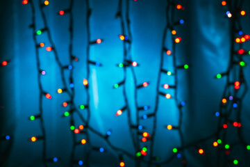 Blured abstract multicolored christmas lights background. De focused Light