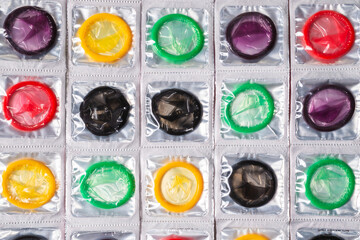 Colorful condoms background. - obrazy, fototapety, plakaty
