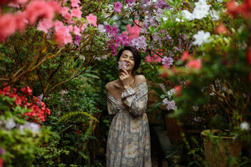 Obraz na płótnie Canvas happy woman in a large garden of azaleas