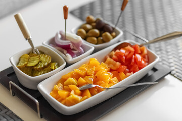 Canned fruits and vegetables. Sliced peaches, onions, pickled cucumbers, bell peppers, olives. Vegetable mix. Snack. Close-up.