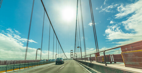 Driving in world famous Golden Gate bridge on a sunny da