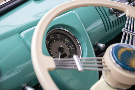 08/08/2020 Portsmouth, Hampshire, UK The speedometer of a vintage car shown through a steering wheel