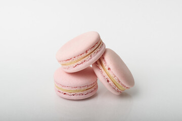 Three tasty macarons on the light background.